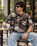 Dark Botanical Floral All-Over Print Unisex Oversized T-Shirt – 240 GSM Heavyweight Streetwear — seated lifestyle photograph